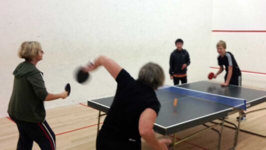 Squash Club Members Partake In A Game Of Table Tennis